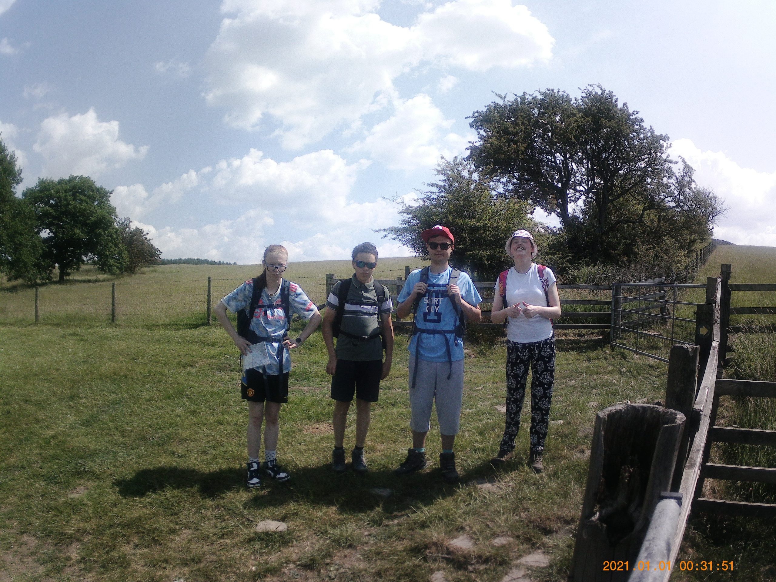 Four students pose for a photo during their sponsored walk