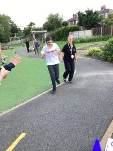 Time for the relay race. Students enjoy running with the baton