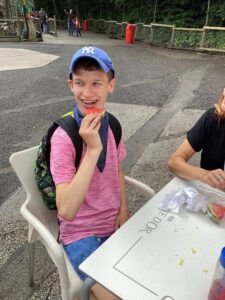 A student enjoying a piece of watermelon for their snack
