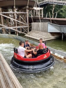 Staff and students enjoy the rapids ride and are very wet!