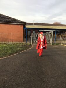 A student enjoys taking part in their Santa costume.